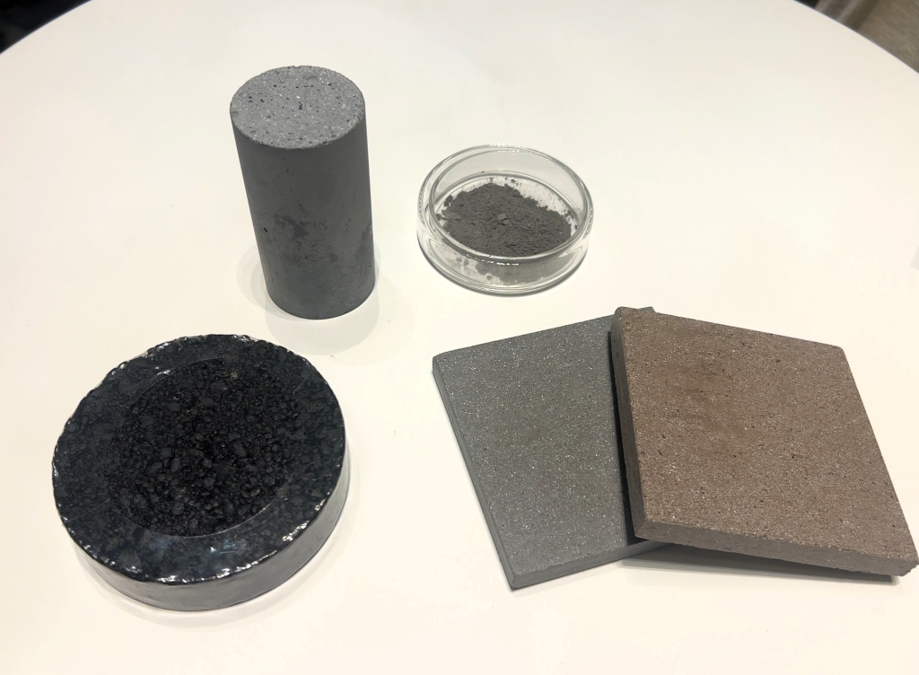 CO2吸収材を配合したコンクリートや床タイルなど。右上は吸収材、CO2を食べる自販機には箱に入ったCO2吸収材2㎏が2つ入っている。